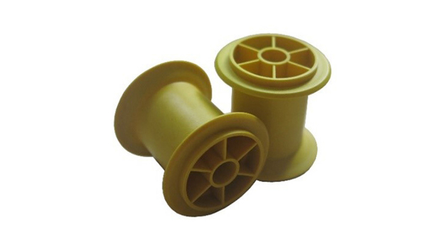 Abb. 2: Spritzgegossene Garnspulen (gelb eingefärbt) aus PLA_6202/GN_40 (60/40 w/w)