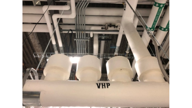 Figure 3: A View of the manifold. It contains pneumatic butterfly valves and insulated CPVC piping. Only one of the outlets is connected. This can serve two cleanroom suites, one at a time. Figure 3: A View of the manifold. It contains pneumatic butterfly valves and insulated CPVC piping. Only one of the outlets is connected. This can serve two cleanroom suites, one at a time.